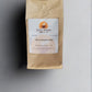 A photo of a standing brown paper coffee bag on a light gray background. The bag has a white label at the center with the orange and brown logo "Great Mornings Coffee & Tea" above the text "White Knight Coffee." Below, the label specifies "Net Wt 8 oz. (227g) ½ lb" with the website "www.greatmorningsofcoffeeandtea.com" at the bottom.
