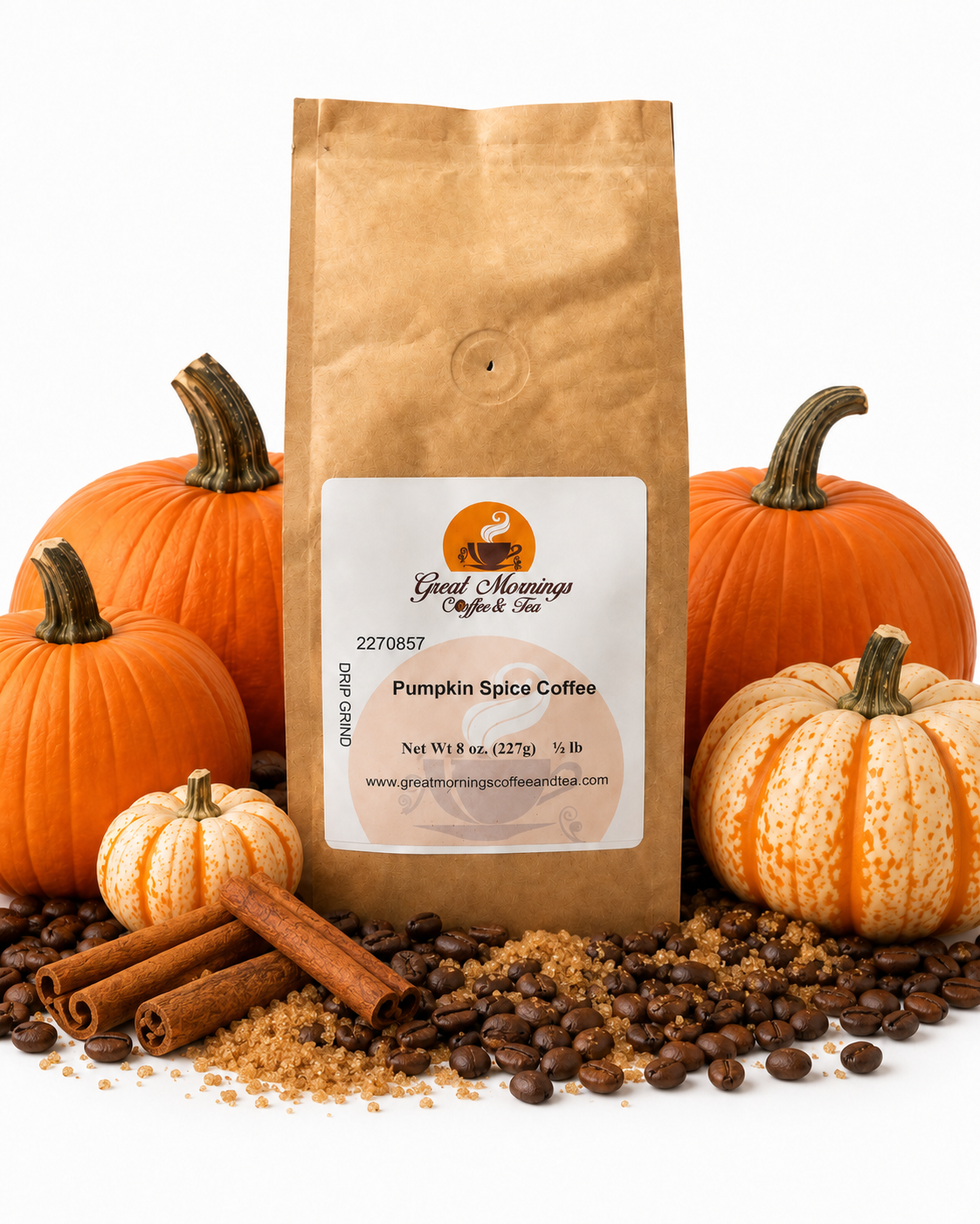 Great Mornings Pumpkin Spice Coffee in a kraft paper bag on a white studio background, surrounded by whole pumpkins, cinnamon sticks, brown sugar, and roasted coffee beans.