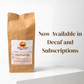 A kraft paper coffee bag labeled 'Blueberry Cream Coffee' by Great Mornings Coffee & Tea stands on a white surface against a white background, with large brown text on the right reading 'Now Available in Decaf and Subscriptions'.