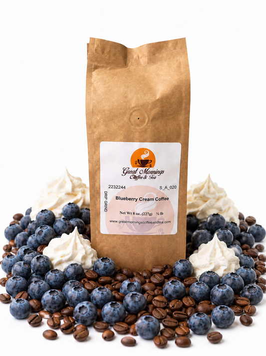 Great Mornings Blueberry Cream Coffee in a kraft paper bag on a white studio background, surrounded by fresh blueberries, dollops of whipped cream, and roasted coffee beans.