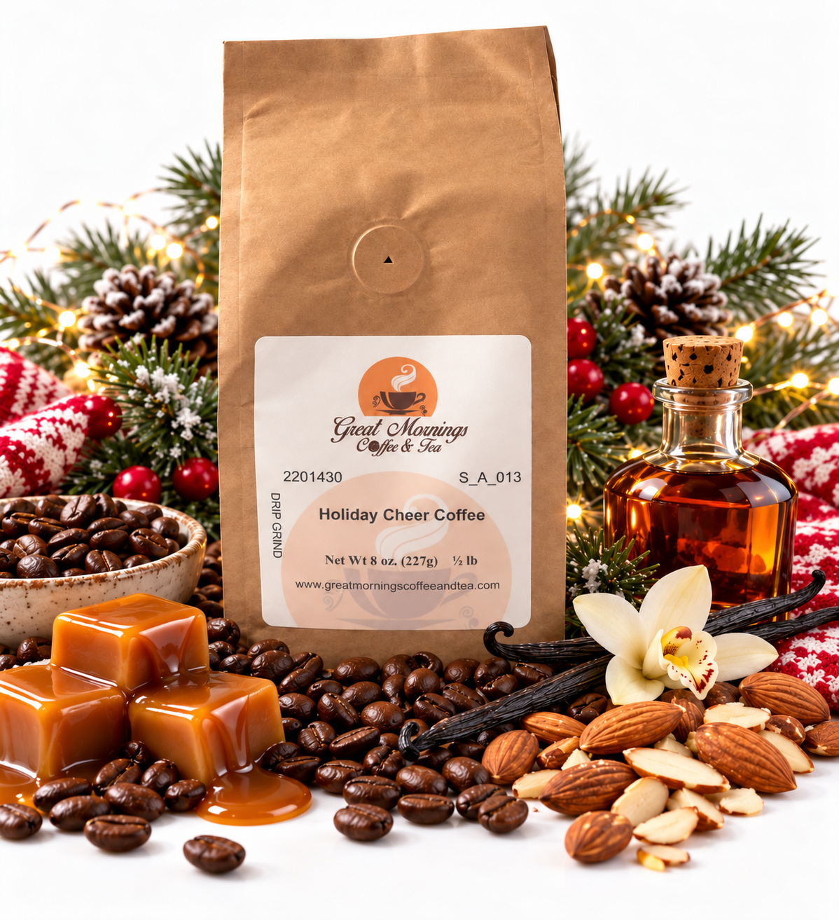 Great Mornings Holiday Cheer Coffee in a kraft paper bag on a white studio background, surrounded by roasted coffee beans, caramel pieces, vanilla beans, toasted almonds, a small bottle of rum, evergreen branches, pinecones, and warm holiday lights.
