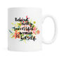 White mug with floral design and motivational quote on a white background